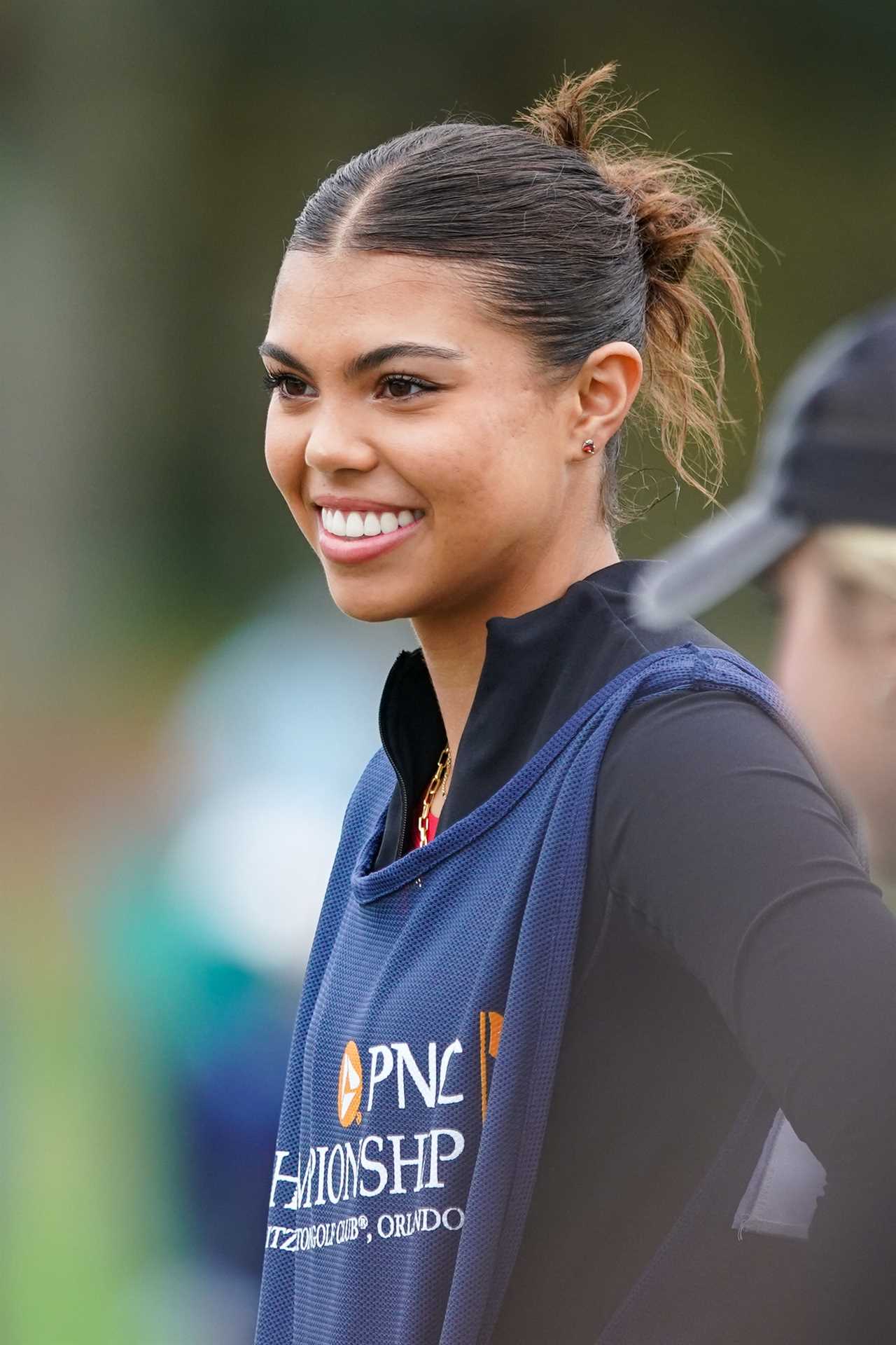 Sam Alexis Woods caddying at the PNC Championship.