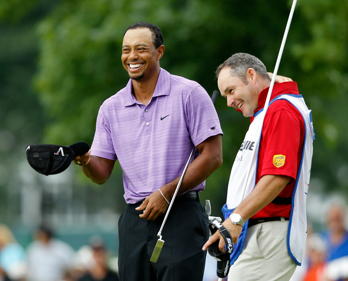 Tiger Woods and his caddie on a golf course.