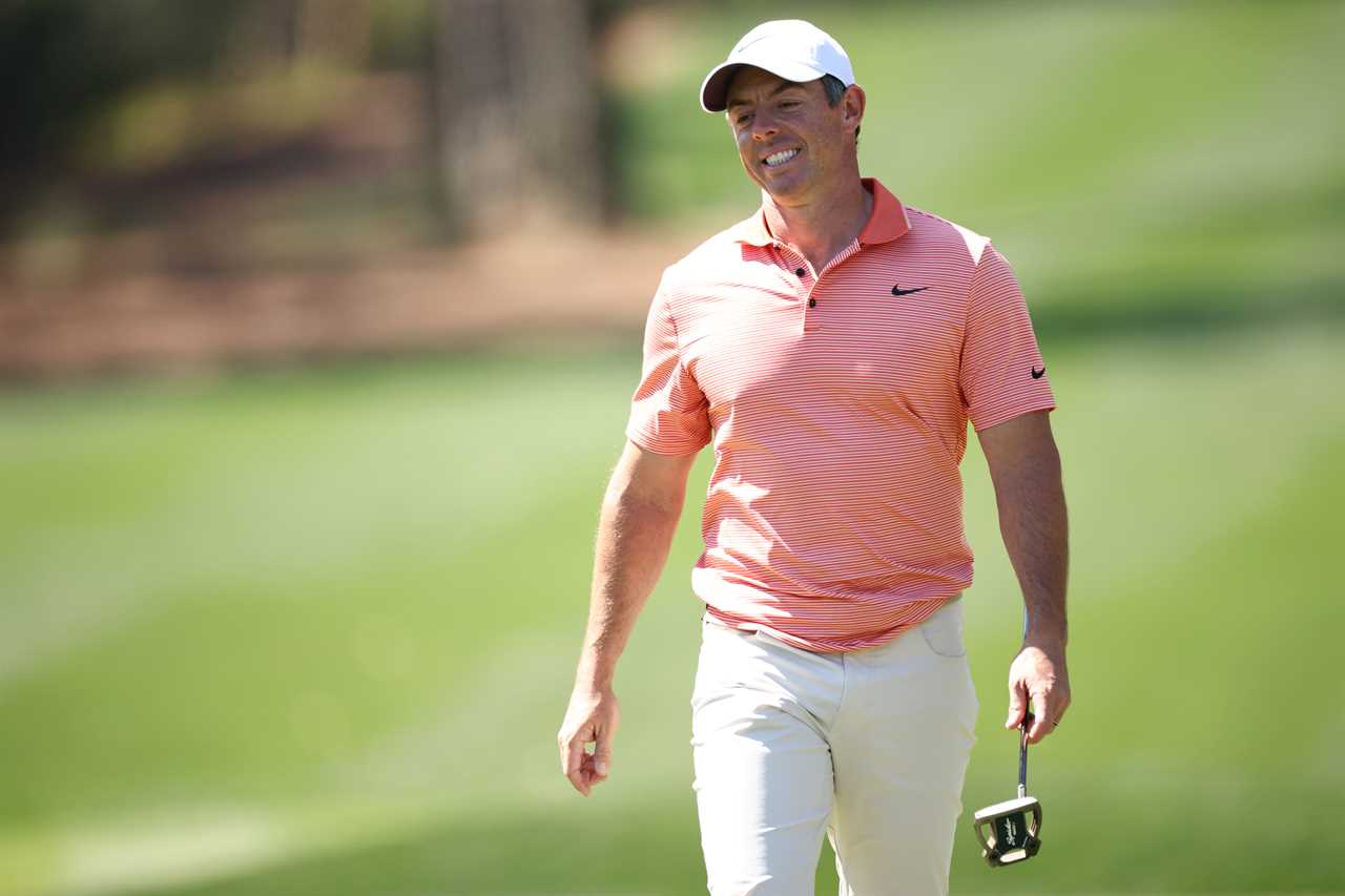 Rory McIlroy walking on a golf course.