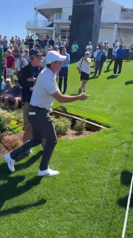 Rory McIlroy taking a fan's phone.