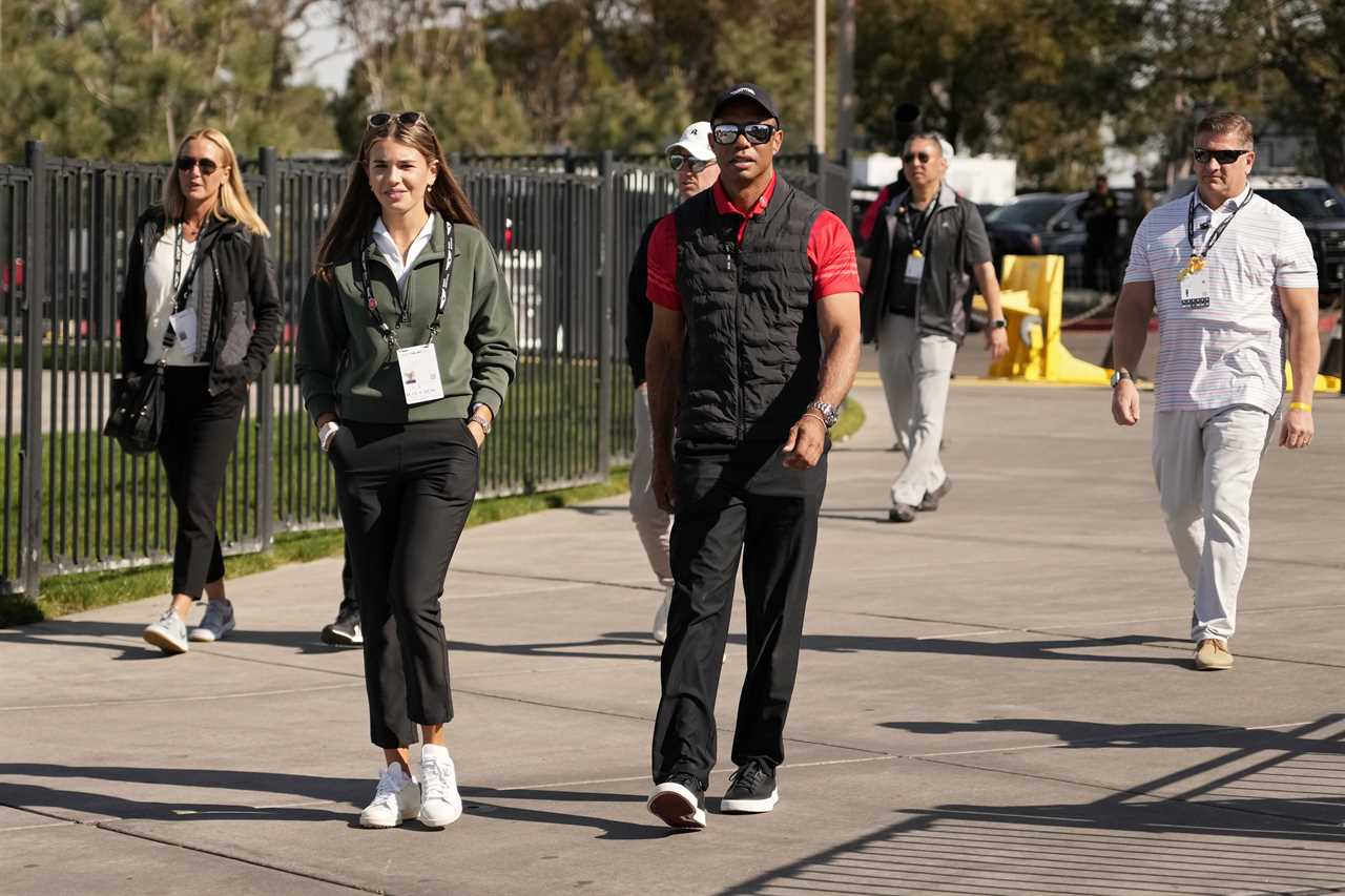 Kai Trump and Tiger Woods walking at a golf course.