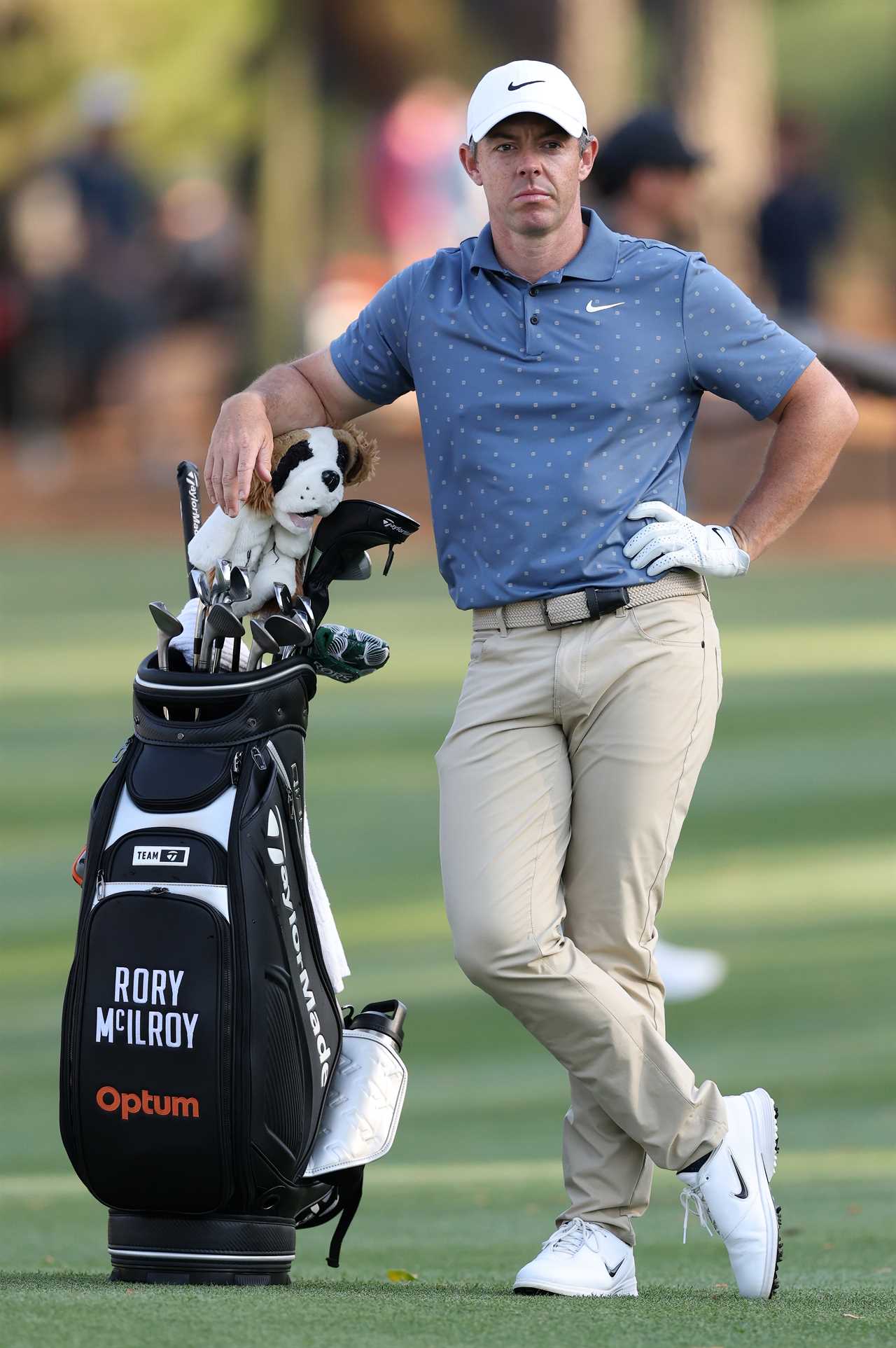 Rory McIlroy leaning on his golf bag.