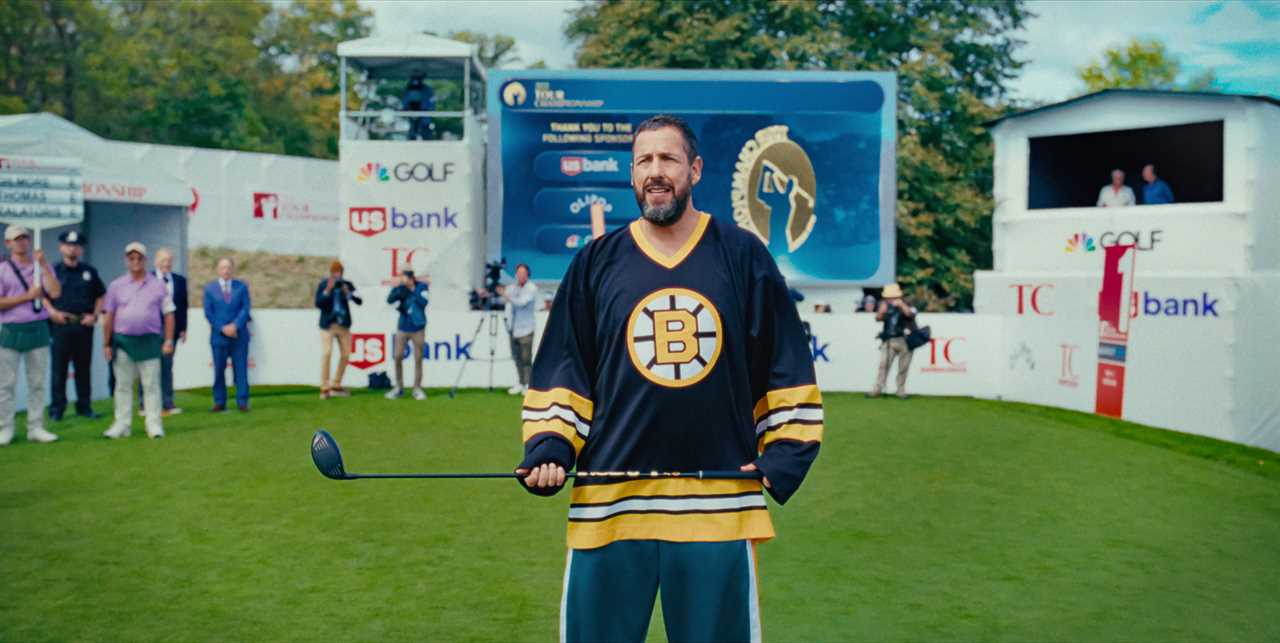 Adam Sandler as Happy Gilmore holding a golf club on a golf course.