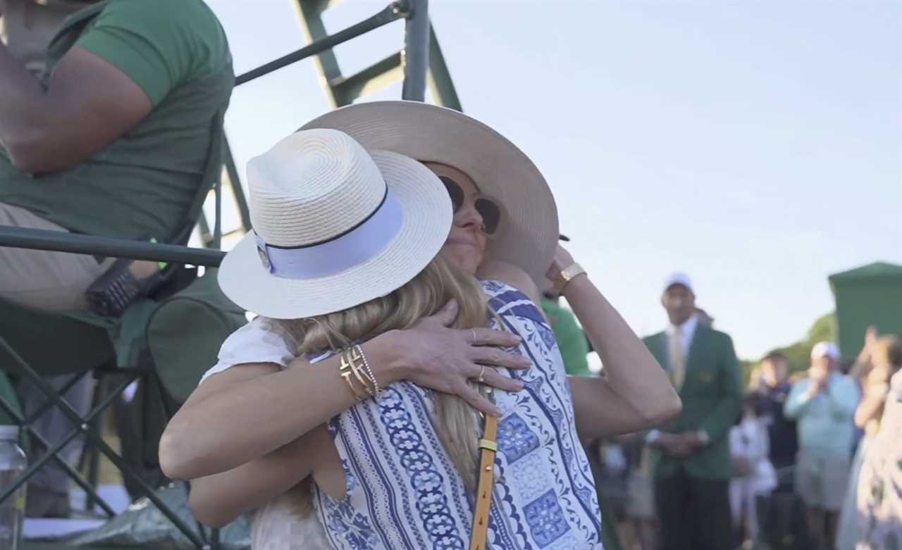 Two women hugging after a golf putt.