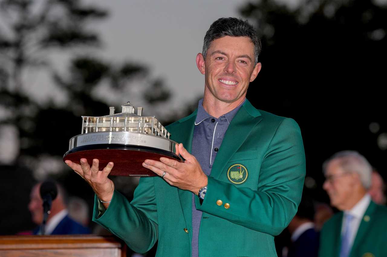 Rory McIlroy holding the Masters Championship trophy.