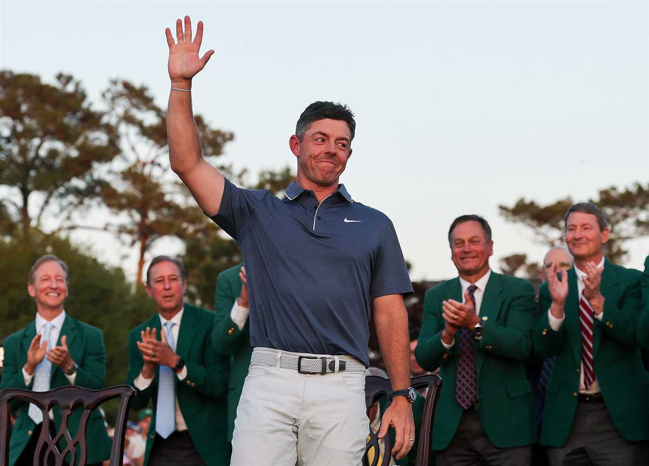 Rory McIlroy waves to the crowd at a ceremony.