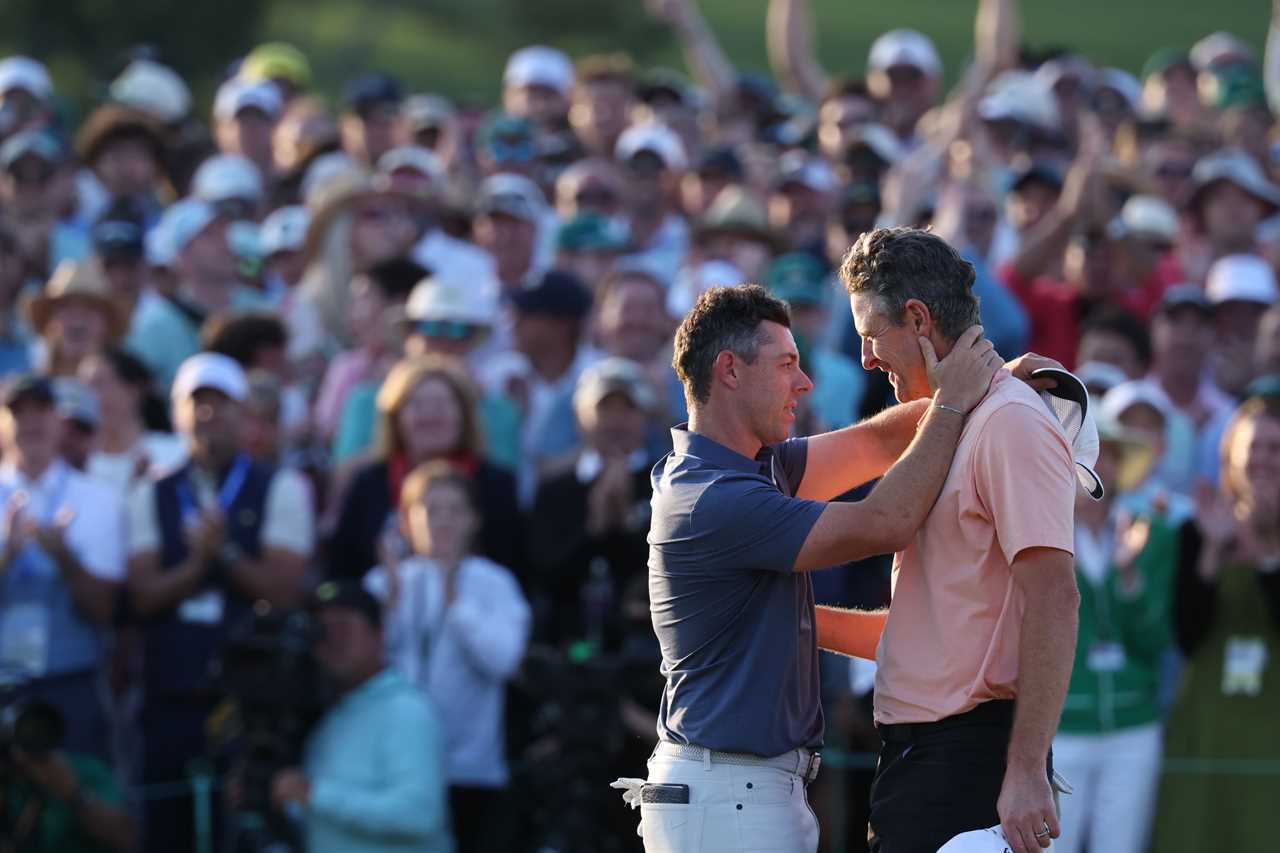 Rory McIlroy and Justin Rose embracing after a golf tournament win.