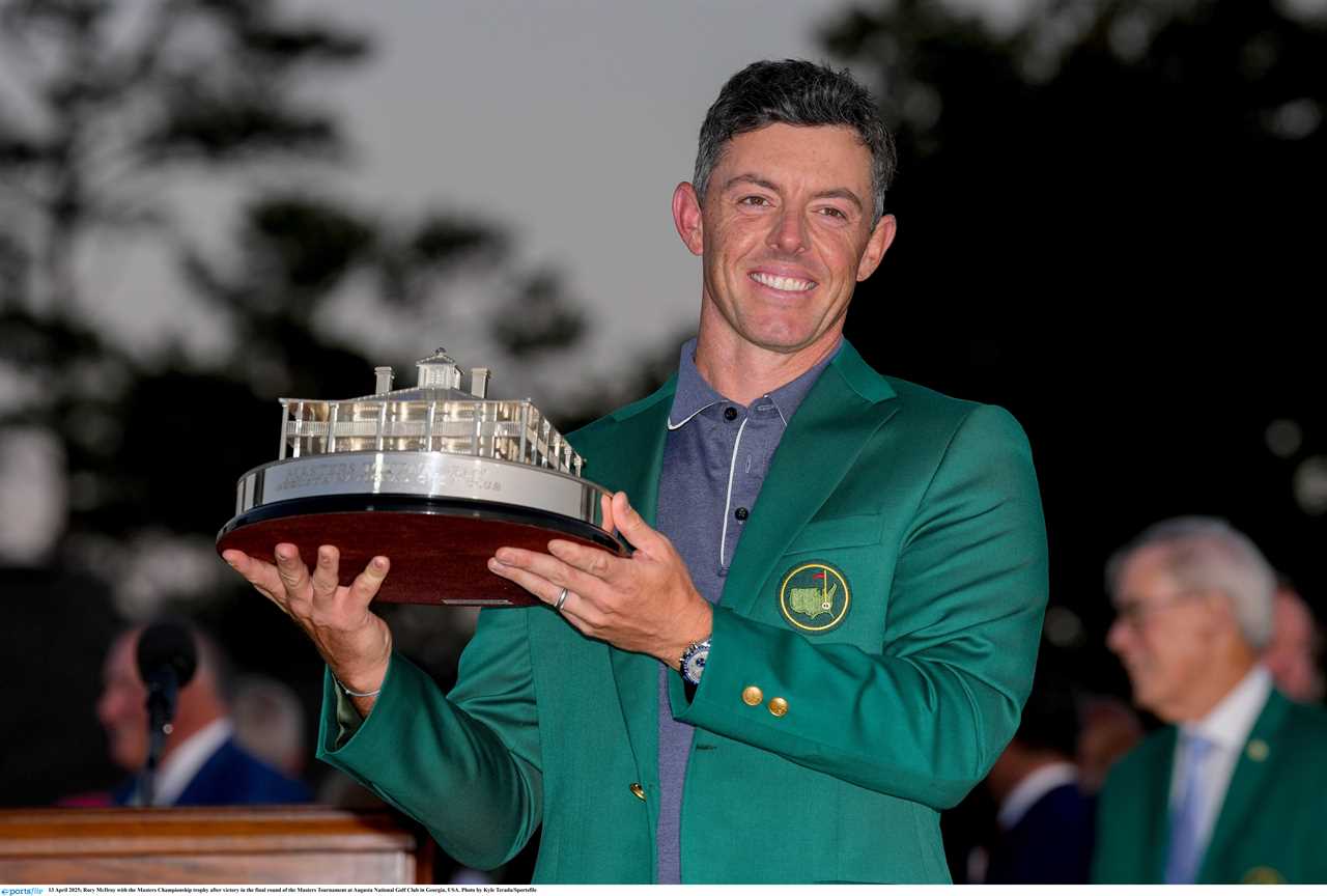 Rory McIlroy holding the Masters Championship trophy.
