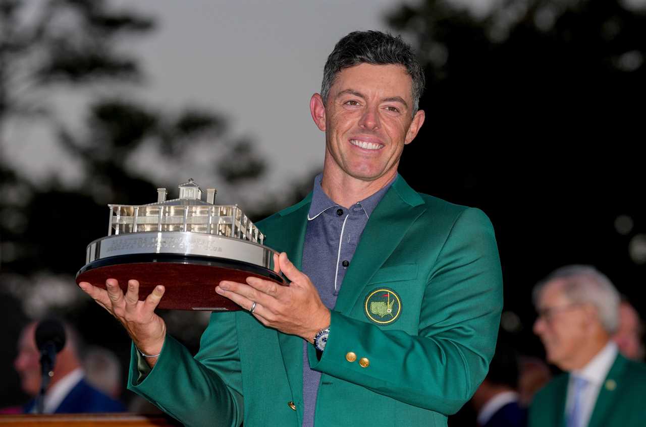 Rory McIlroy holding the Masters Championship trophy.