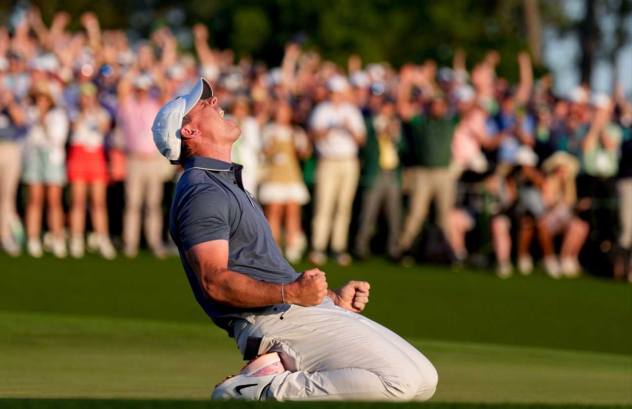 Rory McIlroy celebrating on the 18th green after winning a playoff at the Masters Tournament.