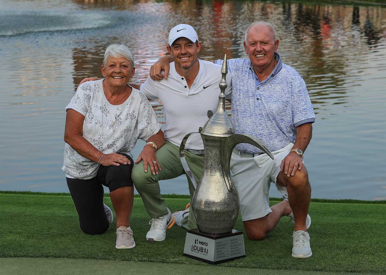 Rory McIlroy with his parents and a trophy.