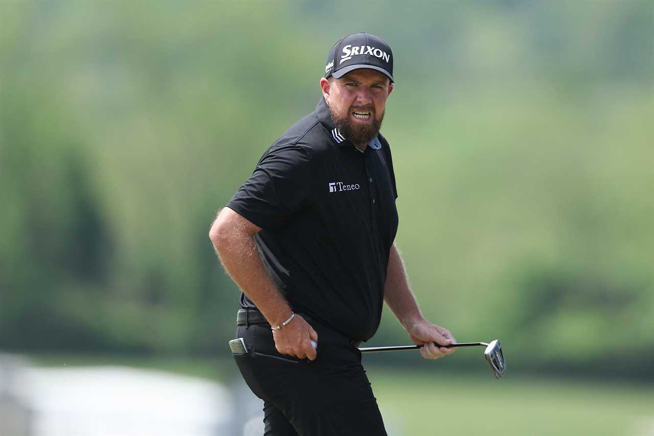 Shane Lowry walking off the green at a golf tournament.