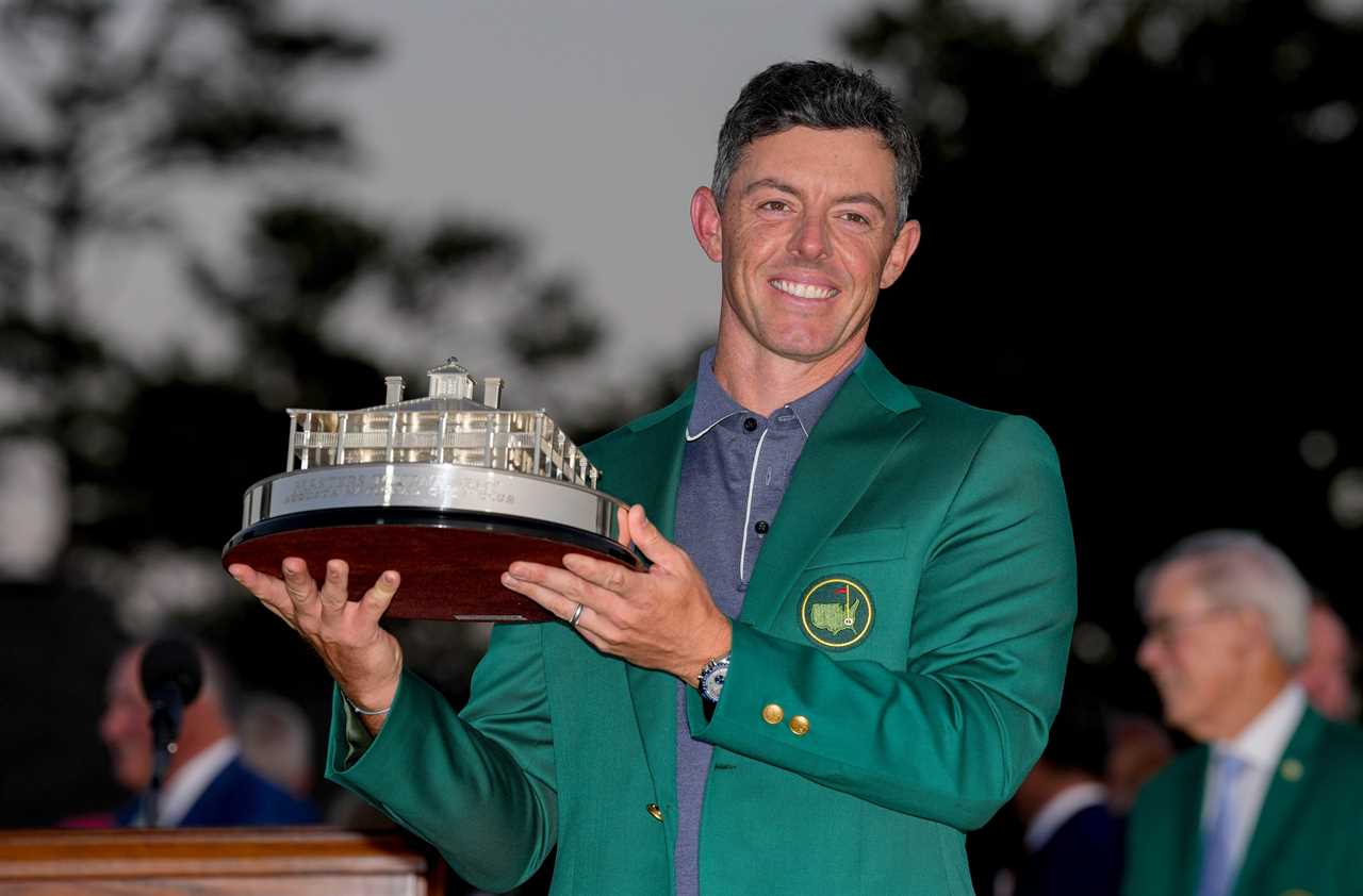 Rory McIlroy holding the Masters Championship trophy.