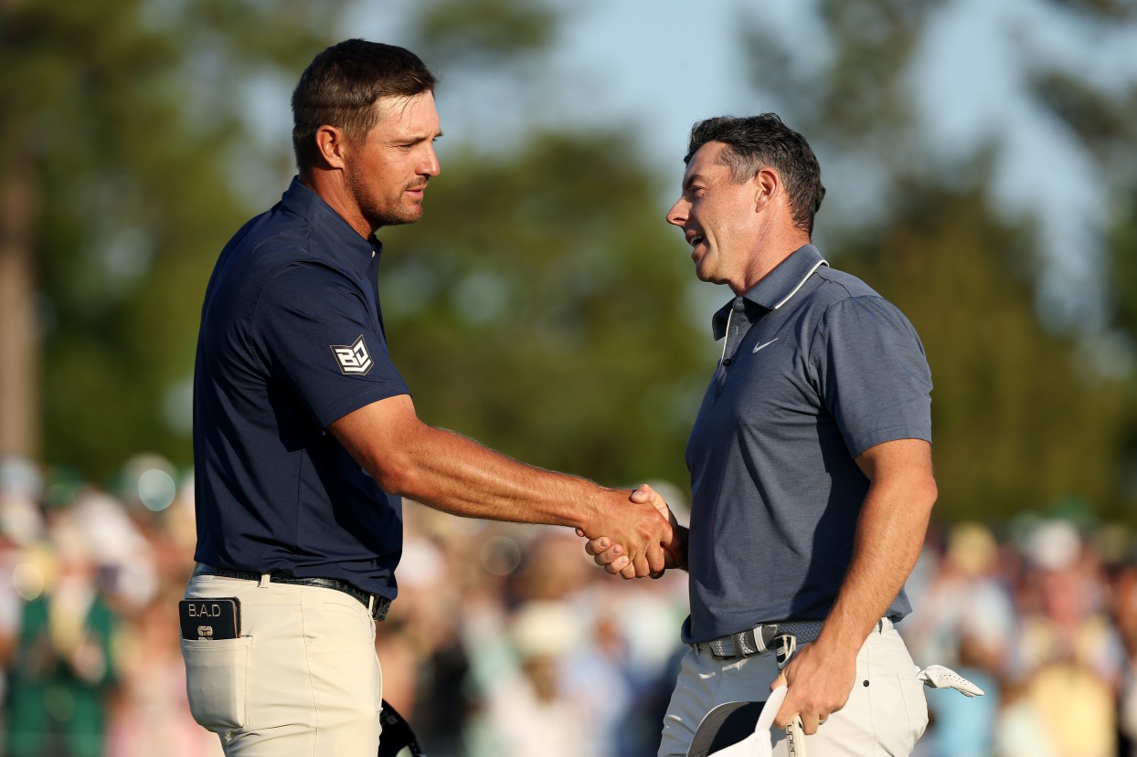 AUGUSTA, GEORGIA - APRIL 13: (R-L) Rory McIlroy of Northern Ireland shakes hands with Bryson DeChambeau of the United States on the 18th hole during the final round of the 2025 Masters Tournament at Augusta National Golf Club on April 13, 2025 in Augusta, Georgia. (Photo by Richard Heathcote/Getty Images)