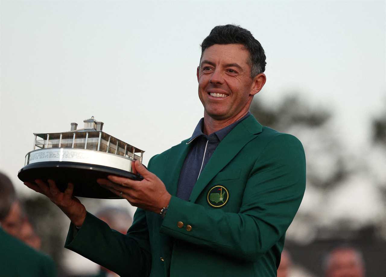 Rory McIlroy holding the Masters Tournament trophy and wearing the green jacket.