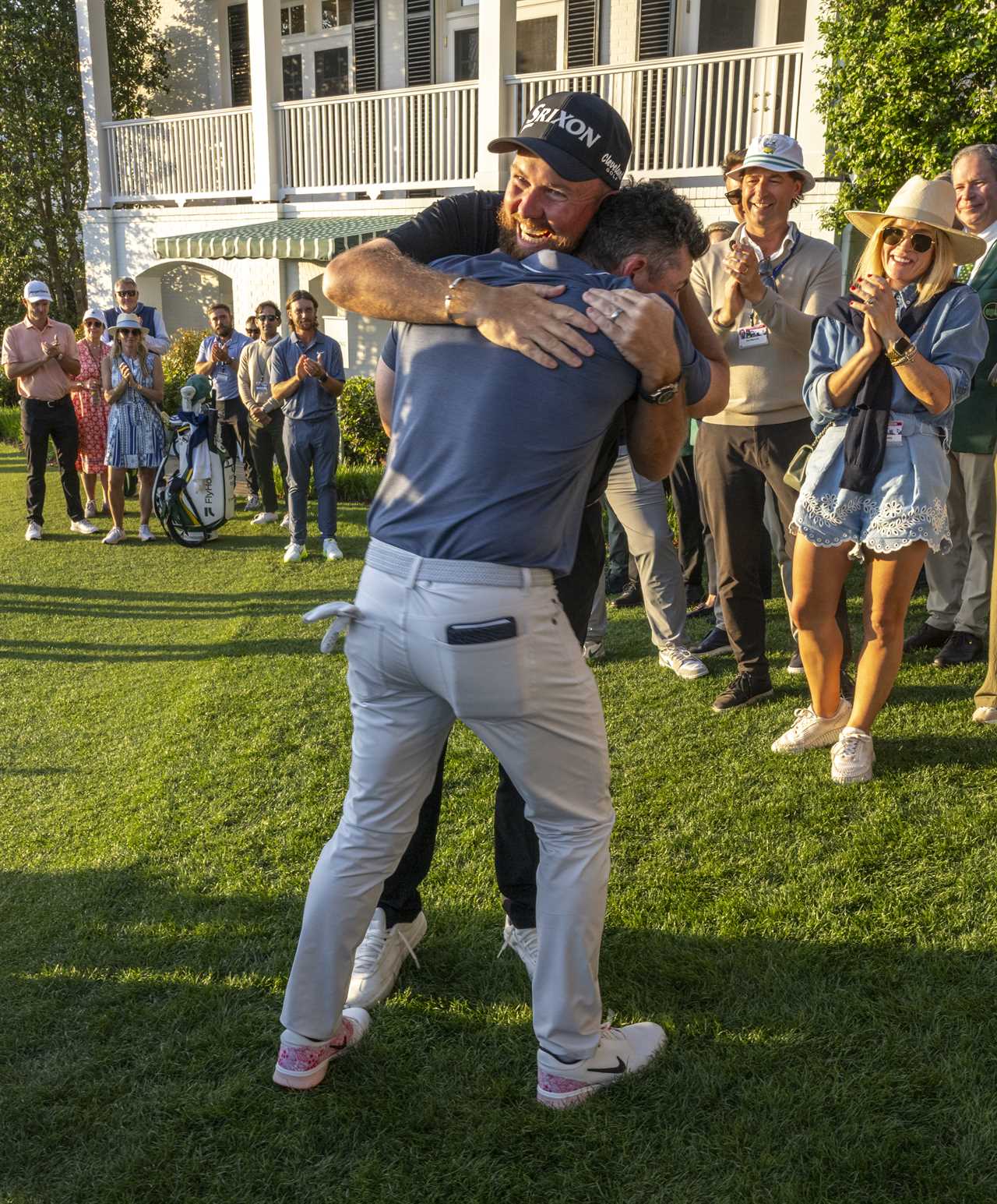 Rory McIlroy and Shane Lowry embracing after McIlroy wins a golf tournament.
