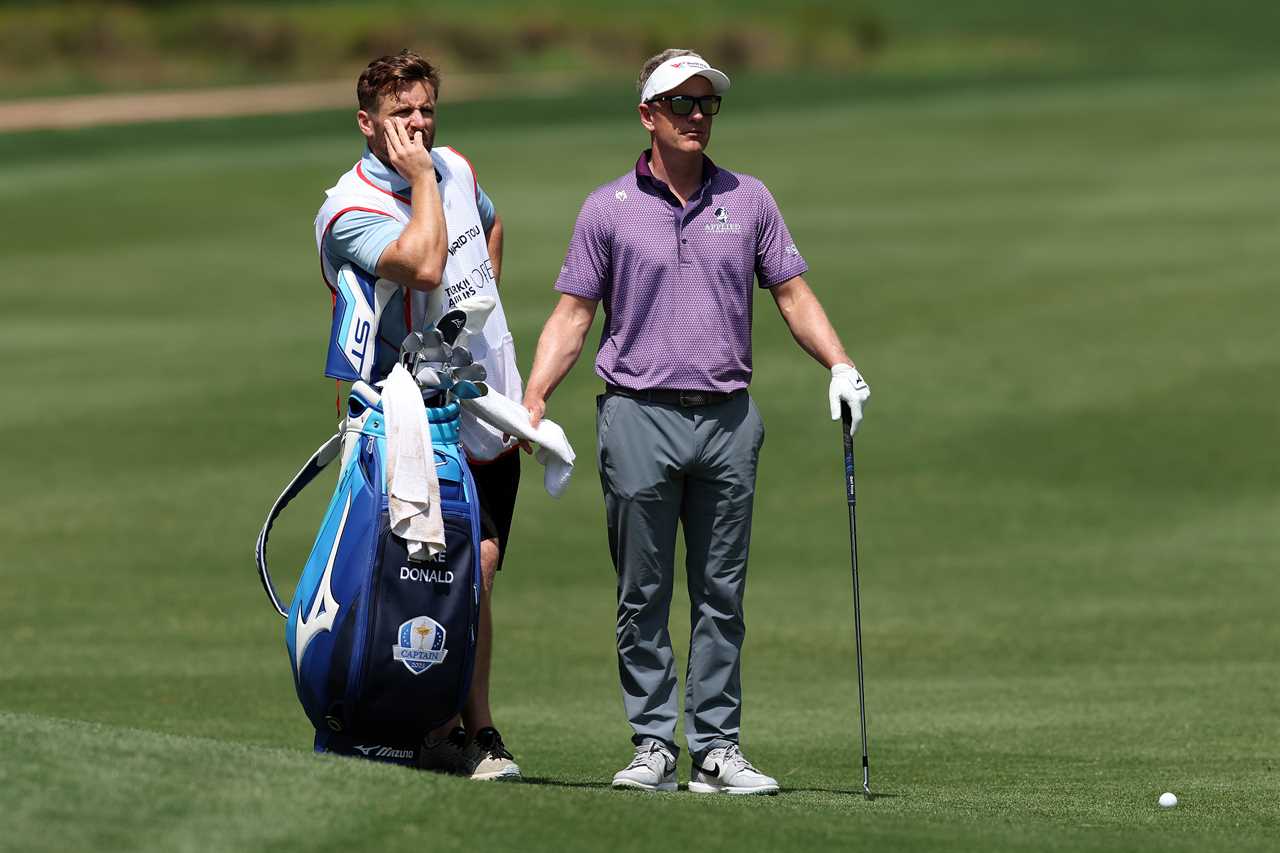 Luke Donald and his caddie Sam Matton on a golf course.