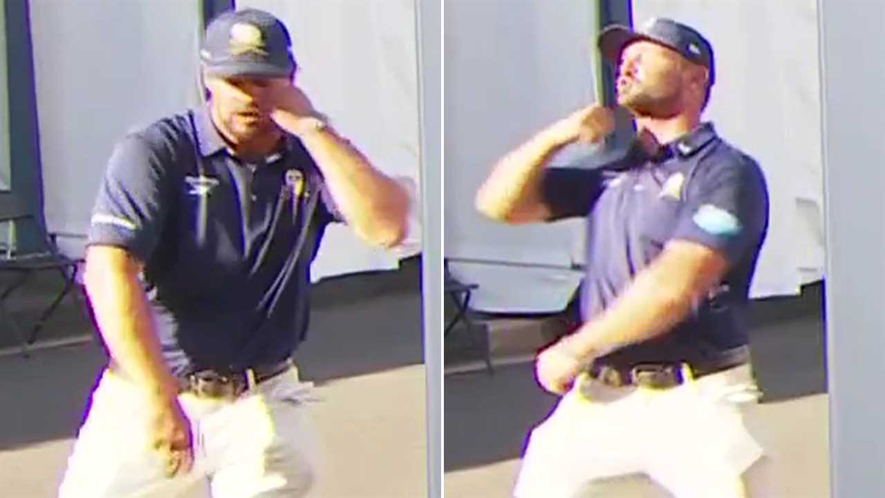 Man in a dark polo shirt and white pants dancing.