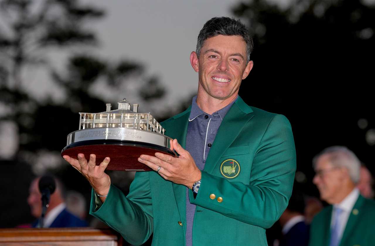 Rory McIlroy holding the Masters Championship trophy.