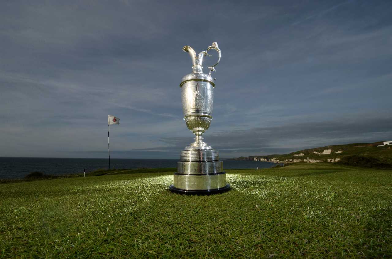The Open Championship trophy on a golf course.