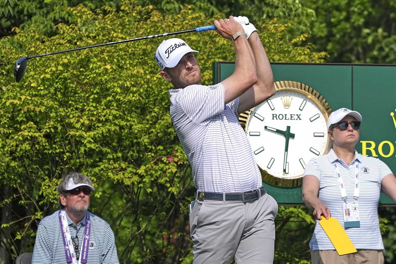 Golfer teeing off at a golf tournament.