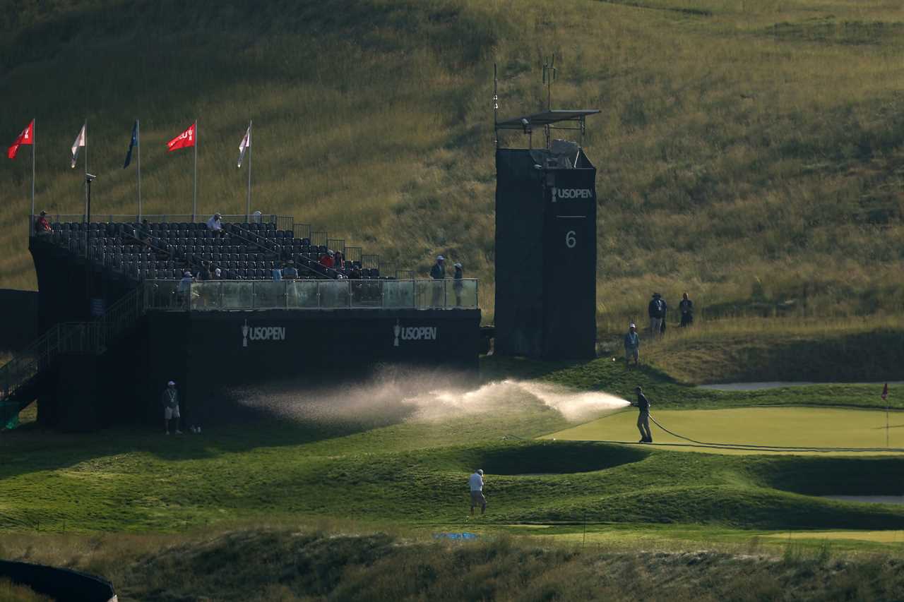 Greenskeeper watering the sixth green at the U.S. Open.