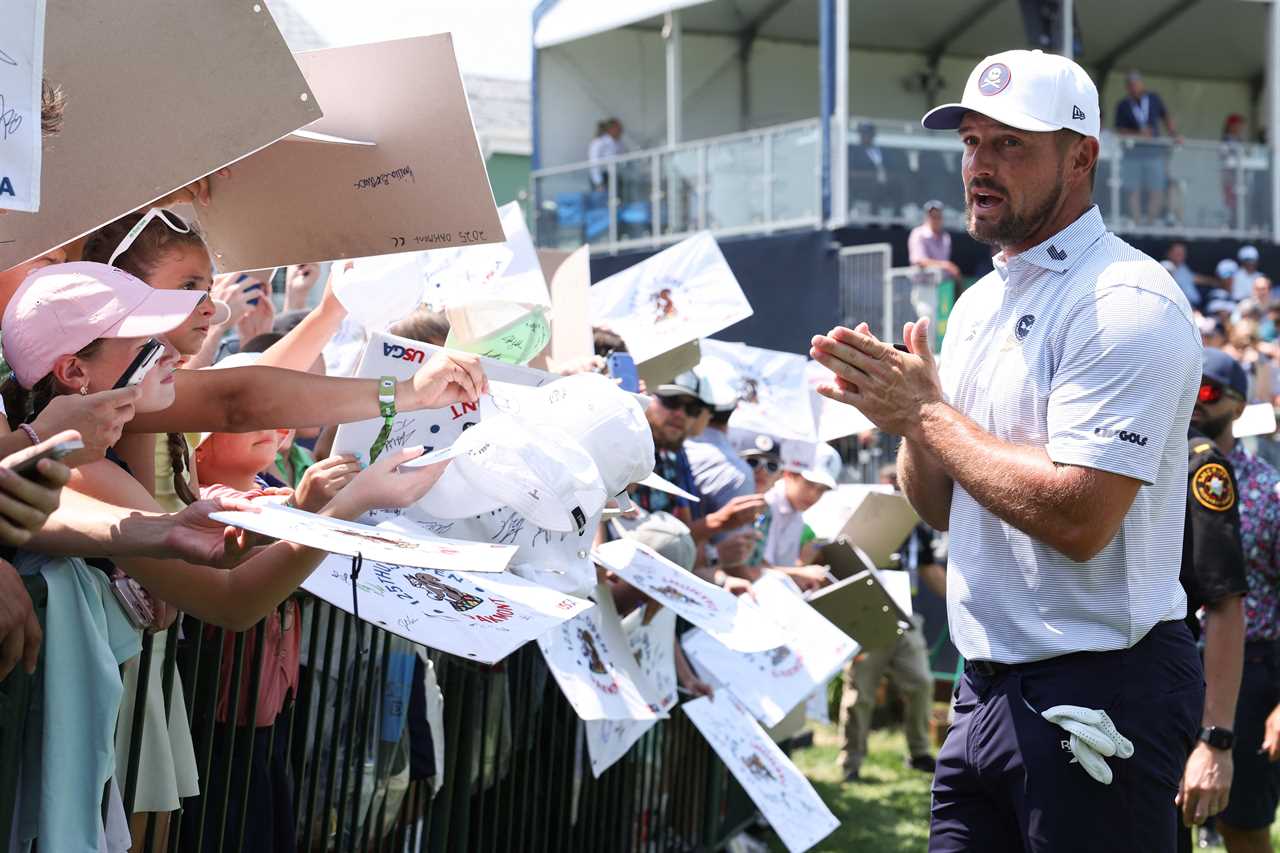 Bryson DeChambeau signing autographs for fans.