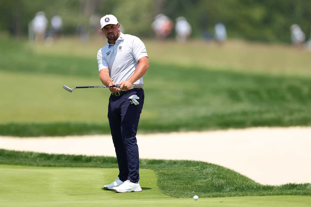 Bryson DeChambeau watches his putt on a golf green.