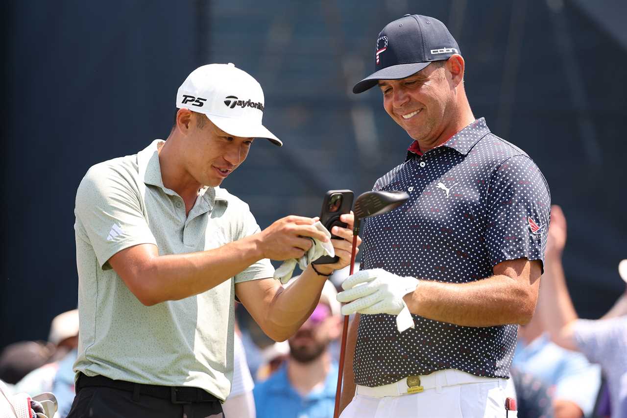 Collin Morikawa photographing Gary Woodland's golf club.