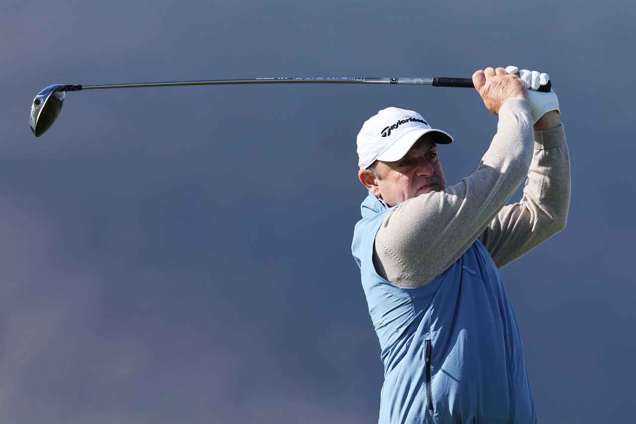 Paul McGinley teeing off at a golf tournament.