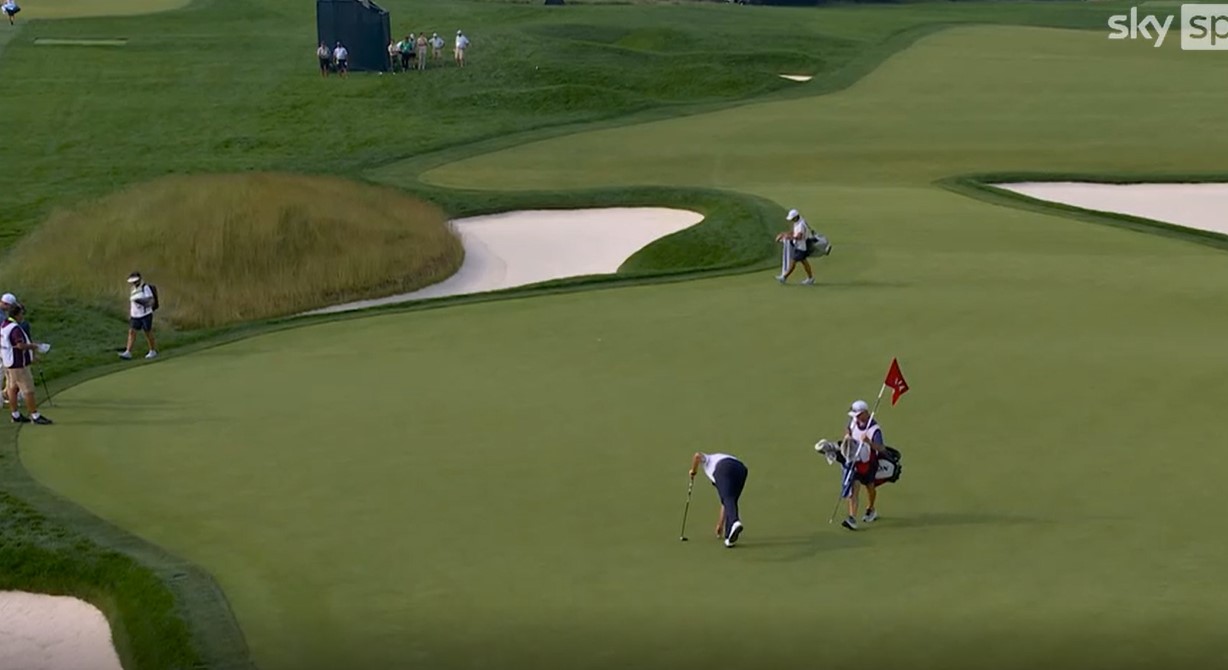 Golfers on a green.