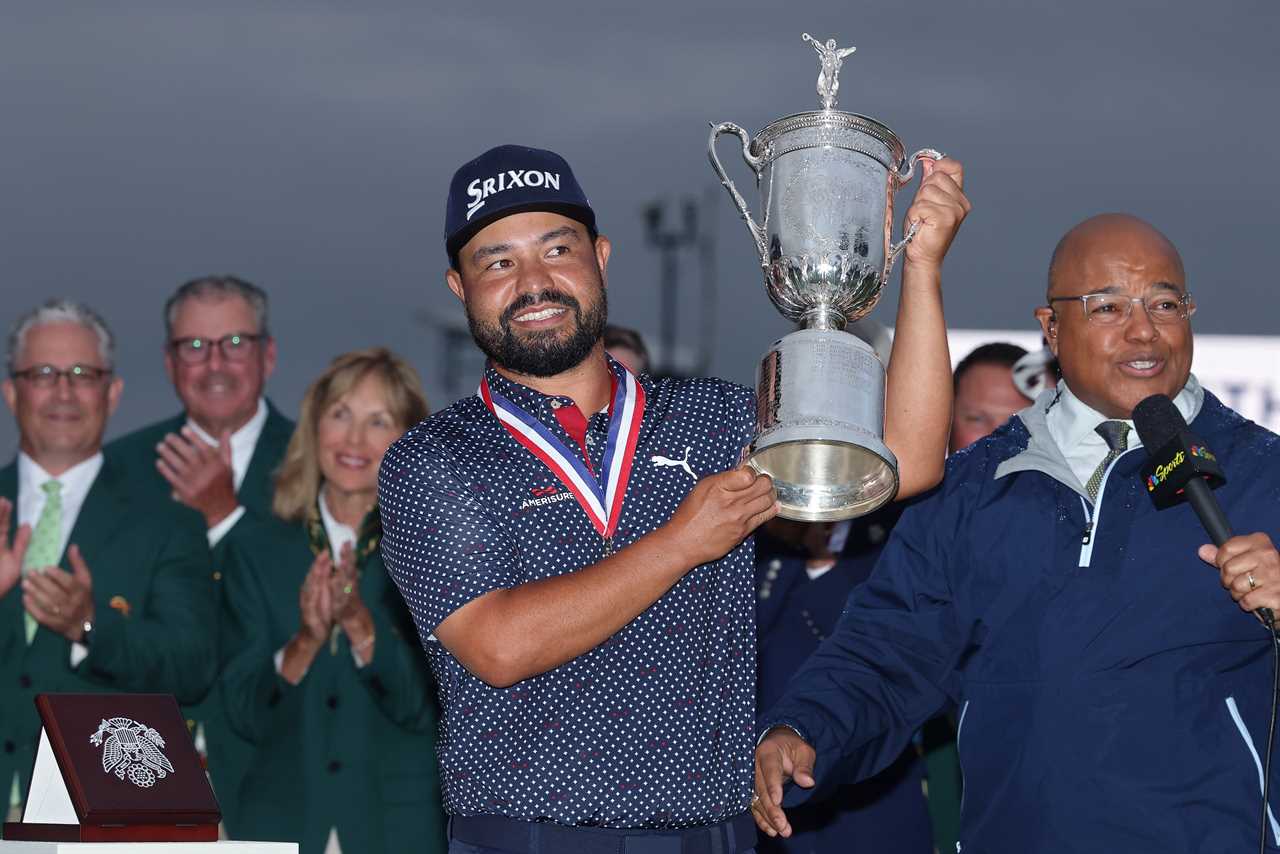J.J. Spaun holding the U.S. Open trophy.
