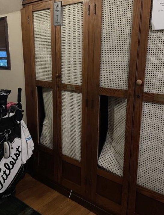 Wooden locker with cane inserts.