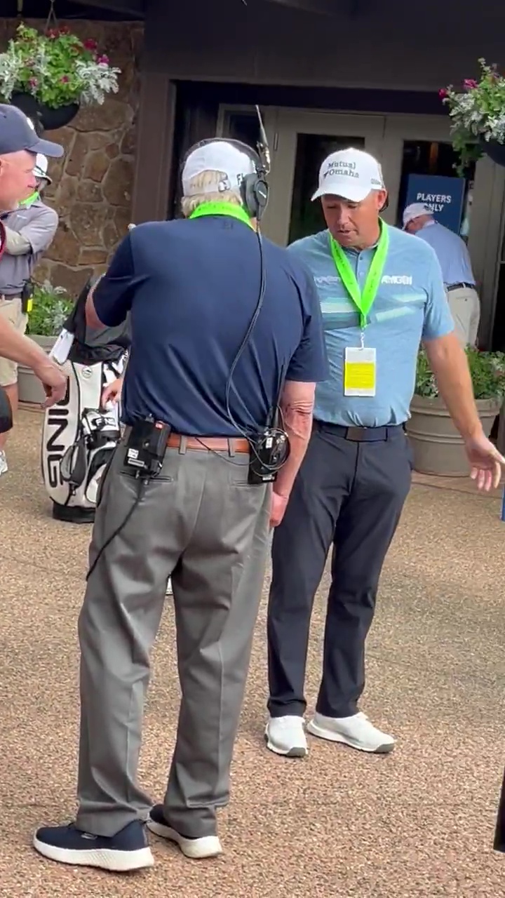 Padraig Harrington speaking with a reporter.