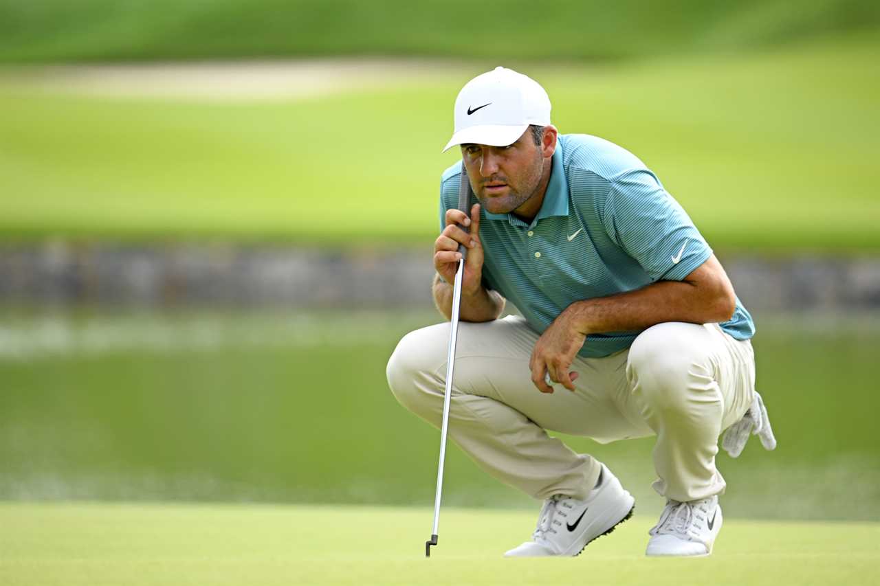 Scottie Scheffler lining up a putt on a golf green.