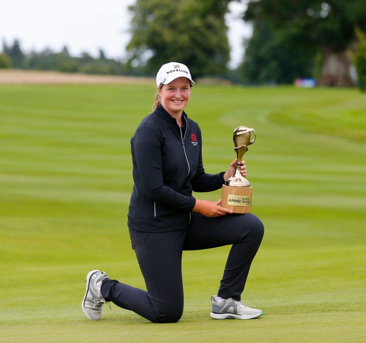 Mandatory Credit: Photo by Peter Fitzpatrick/Action Plus/Shutterstock (15386299ak) Lottie Woad of England holds the winners trophy on her knee; The O'Meara Course at Carton House, Maynooth, County Kildare, Ireland; KPMG Womens Irish Open Golf, Final Round. KPMG Women's Irish Golf Open, Final Round, Maynooth, County Kildare, Ireland - 06 Jul 2025