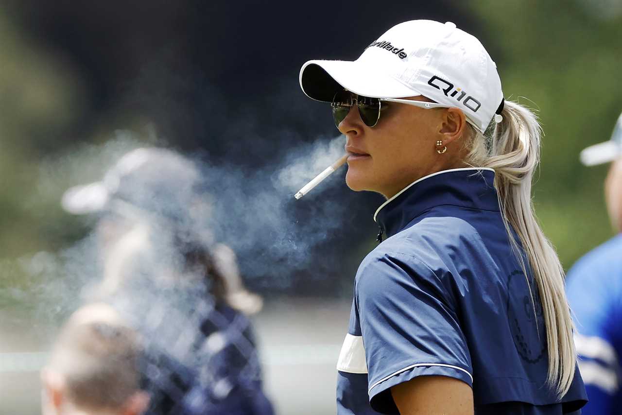 Charley Hull of England smoking a cigarette.