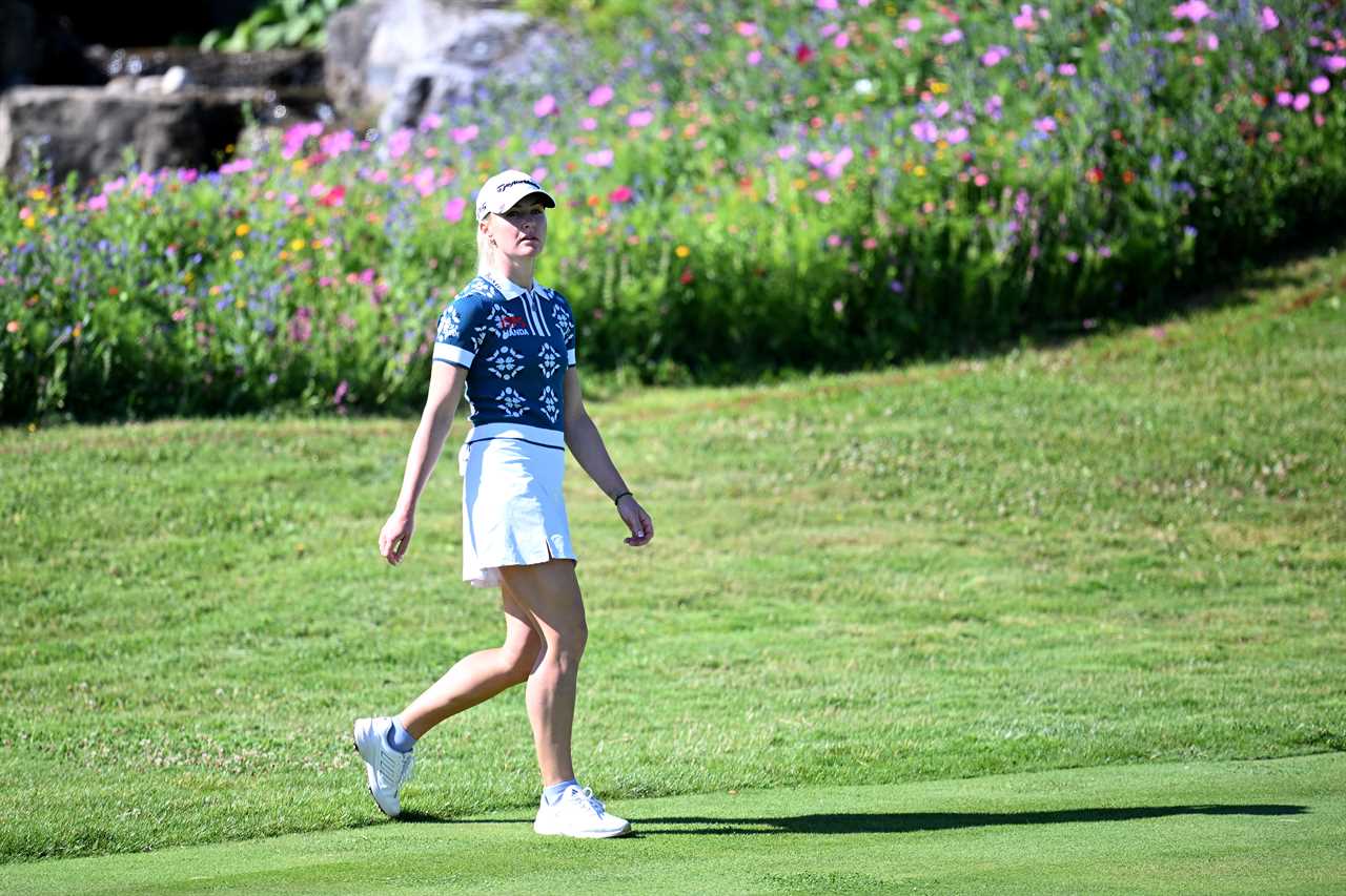 Charley Hull walking on a golf course.
