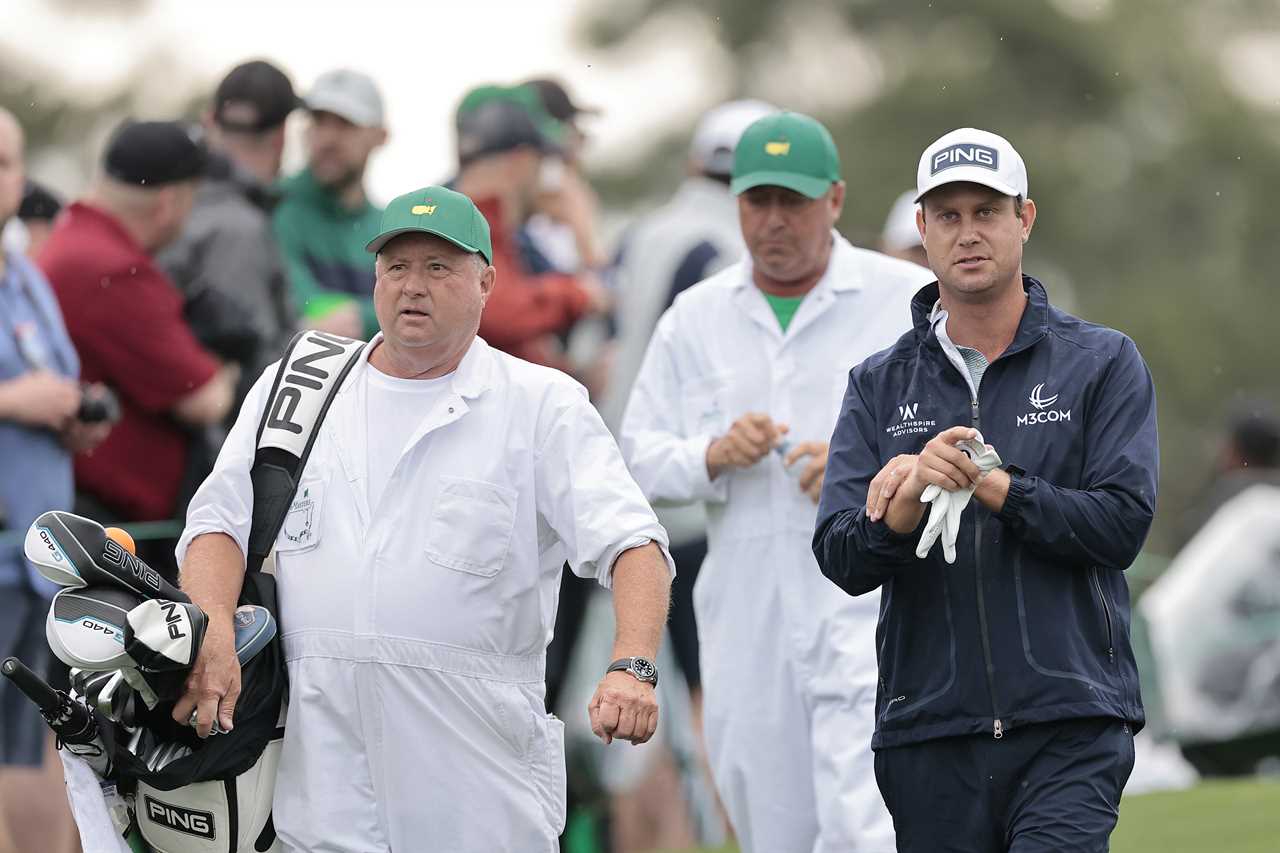 Harris English and his caddie walking at a golf tournament.