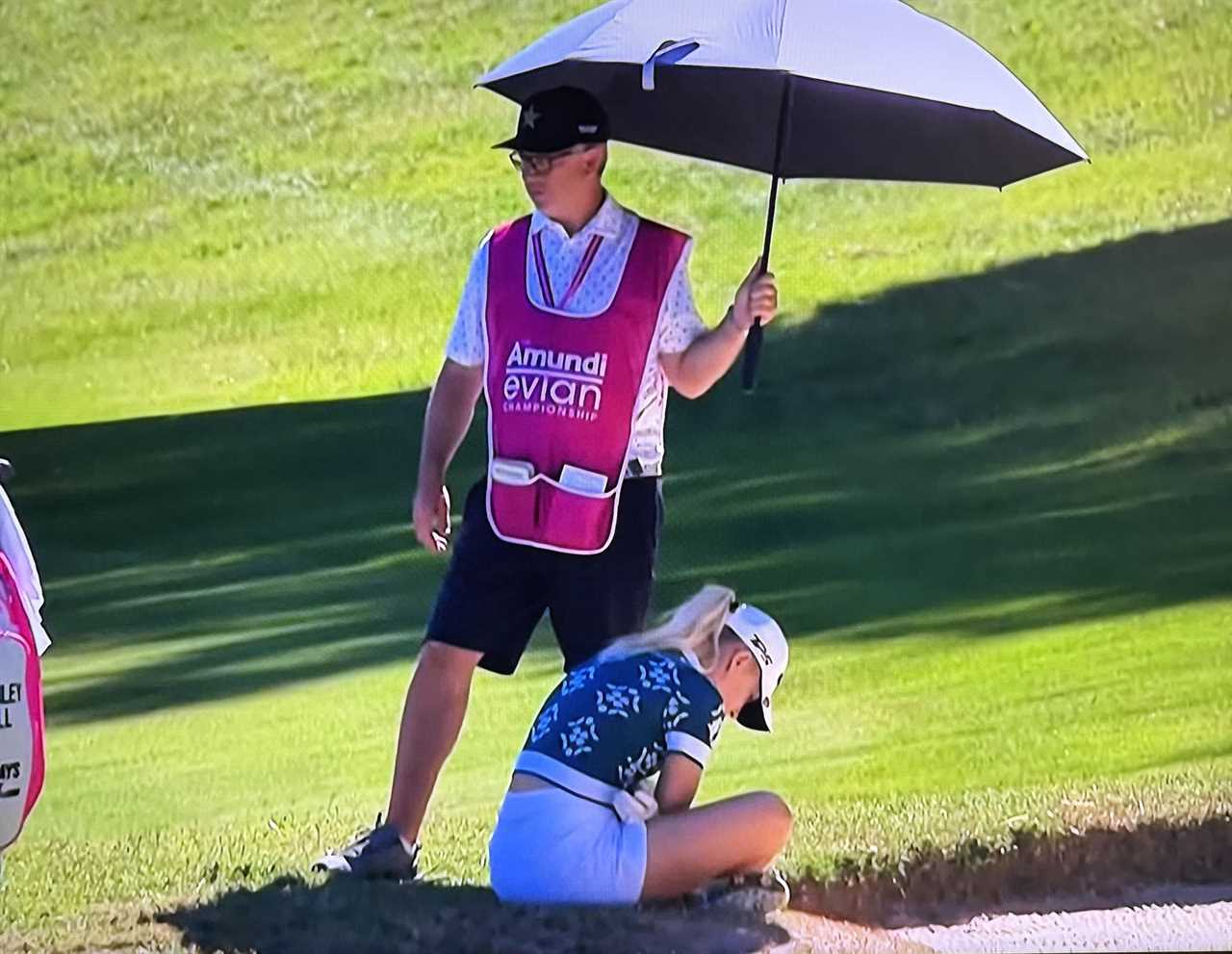 Golfer Charley Hull collapses on the course.