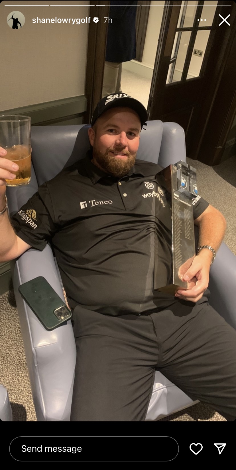 Golfer Shane Lowry holding a trophy and a drink.