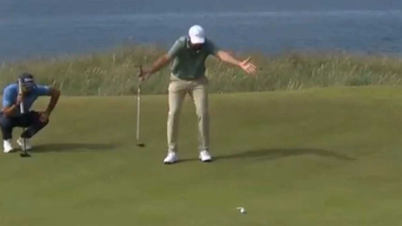 Golfer reacting to a missed putt.