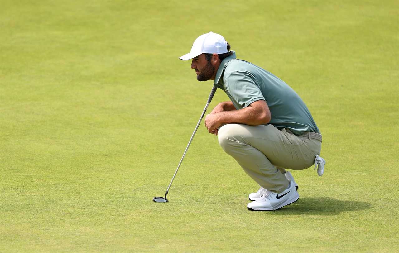 Scottie Scheffler lining up a putt on the green.