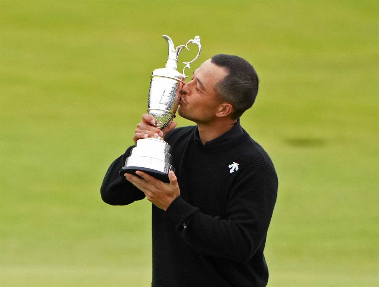 Xander Schauffele kisses the Claret Jug after winning The Open Championship.