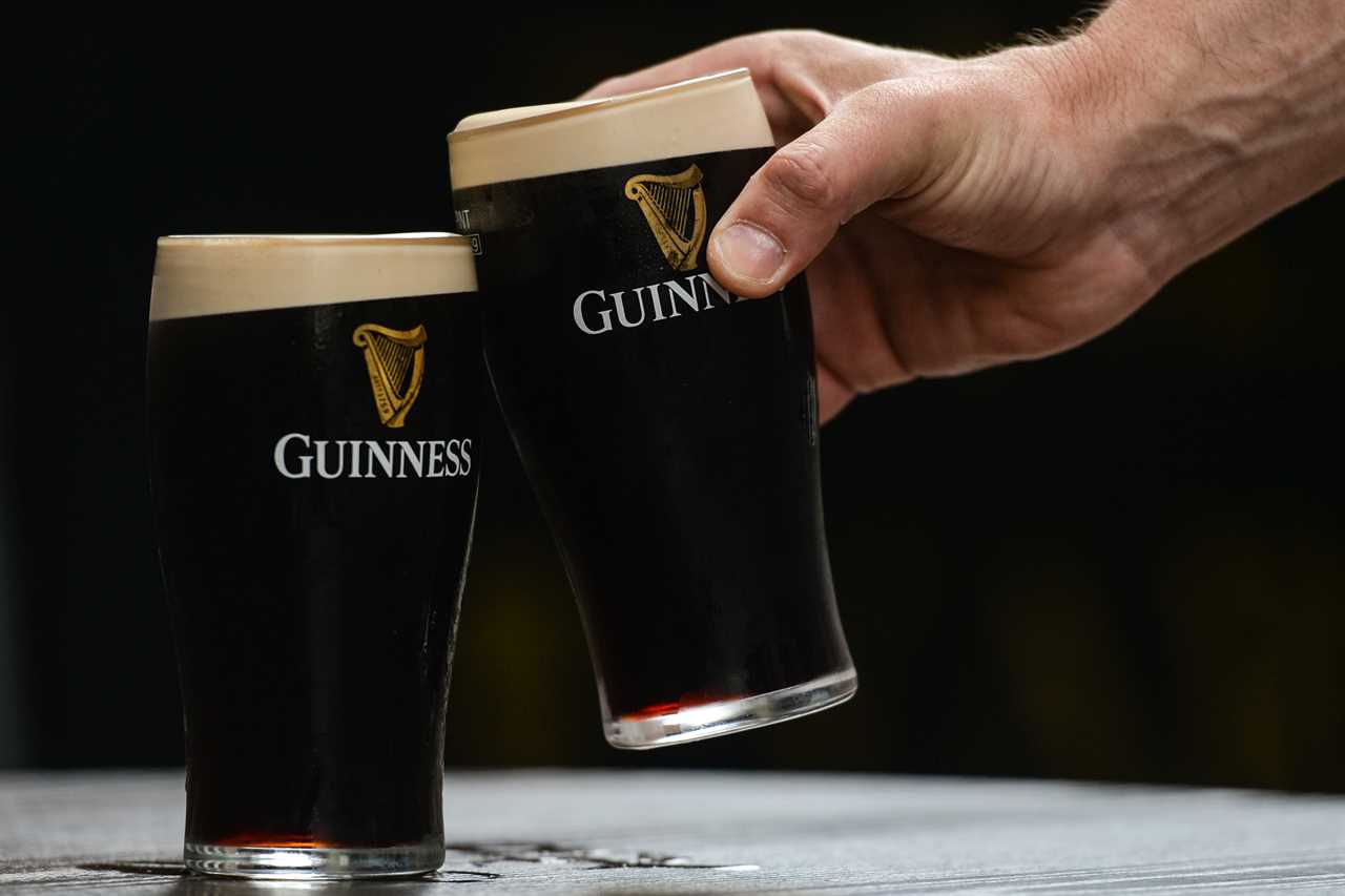 Person drinking a Guinness 0.0 alcohol-free beer.