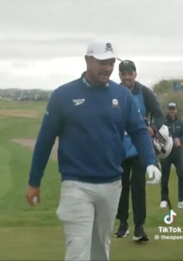 Golfer walking on a golf course.
