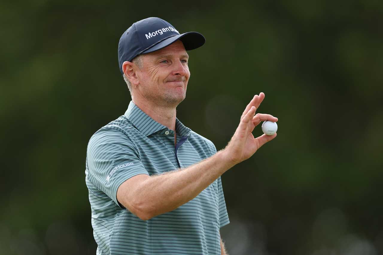 Justin Rose holding a golf ball.