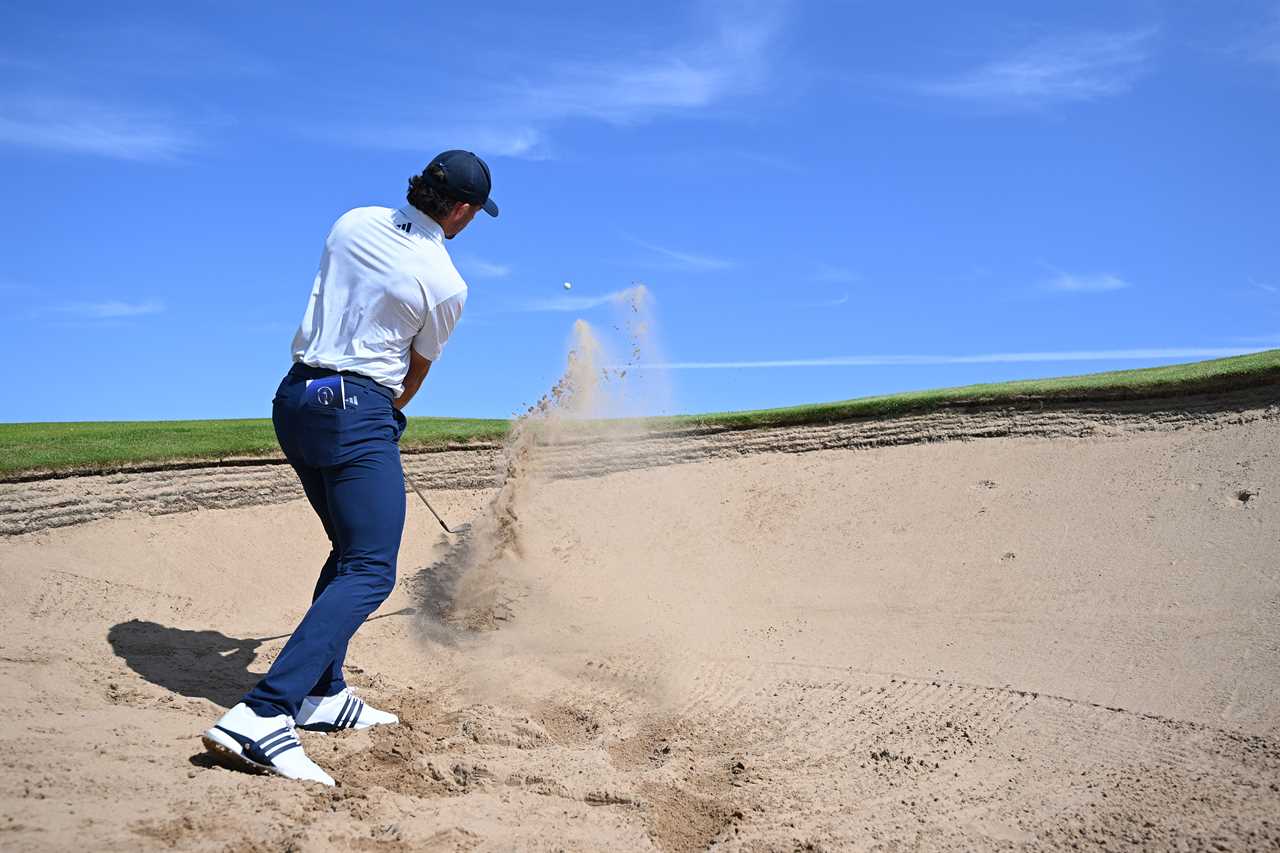 Golfer hitting a shot from a sand trap.