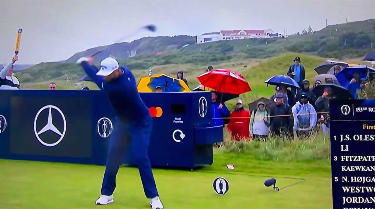 Golfer taking a swing on a golf course.