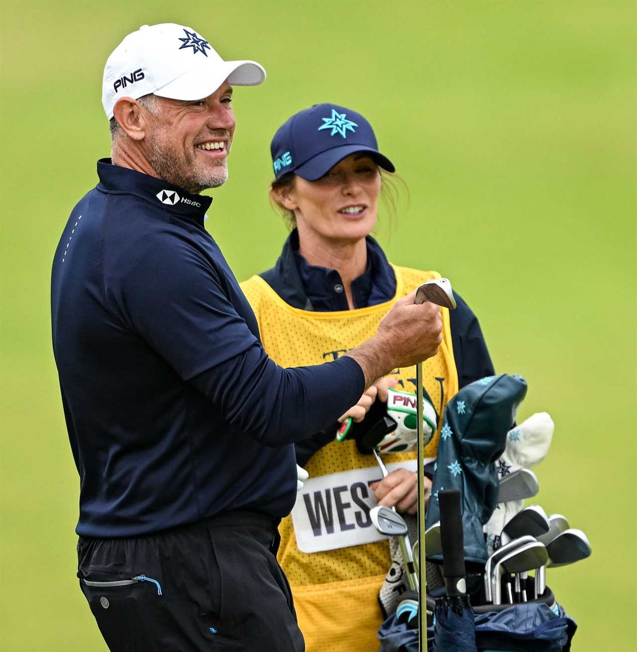 Lee Westwood with his wife and caddie at a golf tournament.